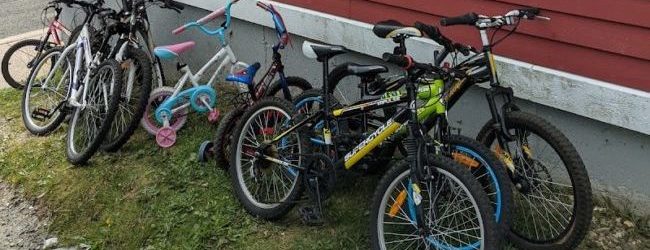 An assortment of refurbished childrens' bikes outside the Buckmasters Circle Community Centre